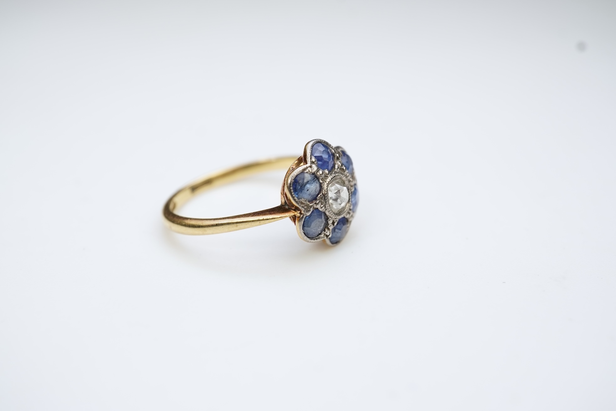 A sapphire and diamond cluster ring, early 20th century
